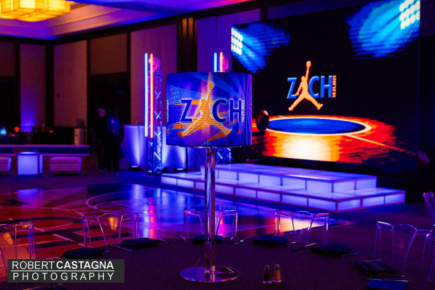 Custom illuminated basketball-themed centerpiece in front of a coordinated branded stage