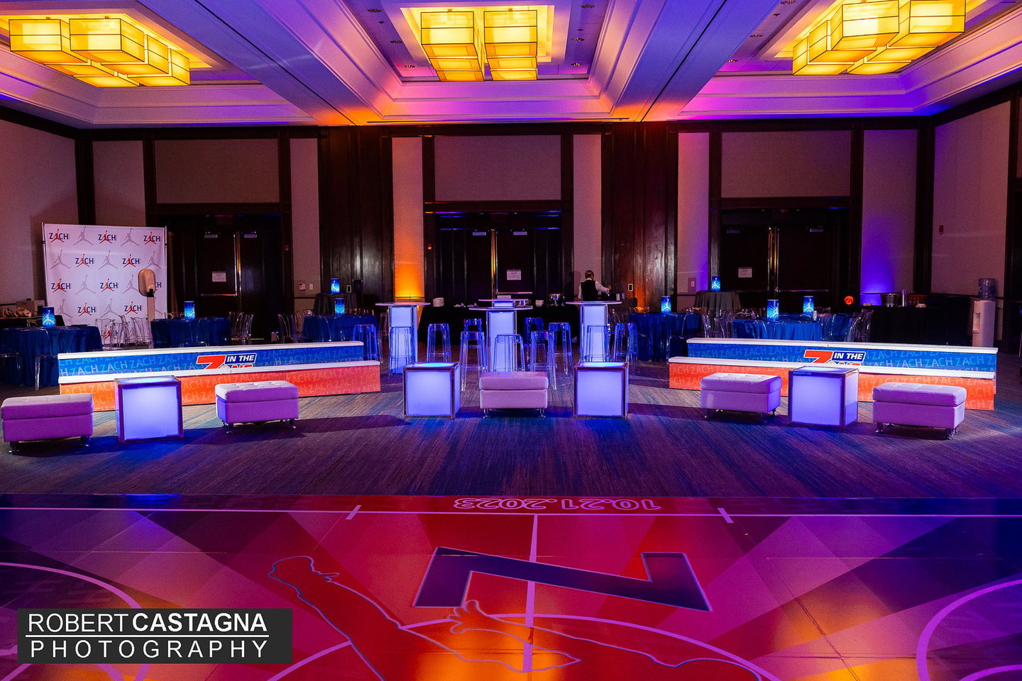 Custom branded basketball bleachers with illuminated lounge furniture and coordinated event graphics