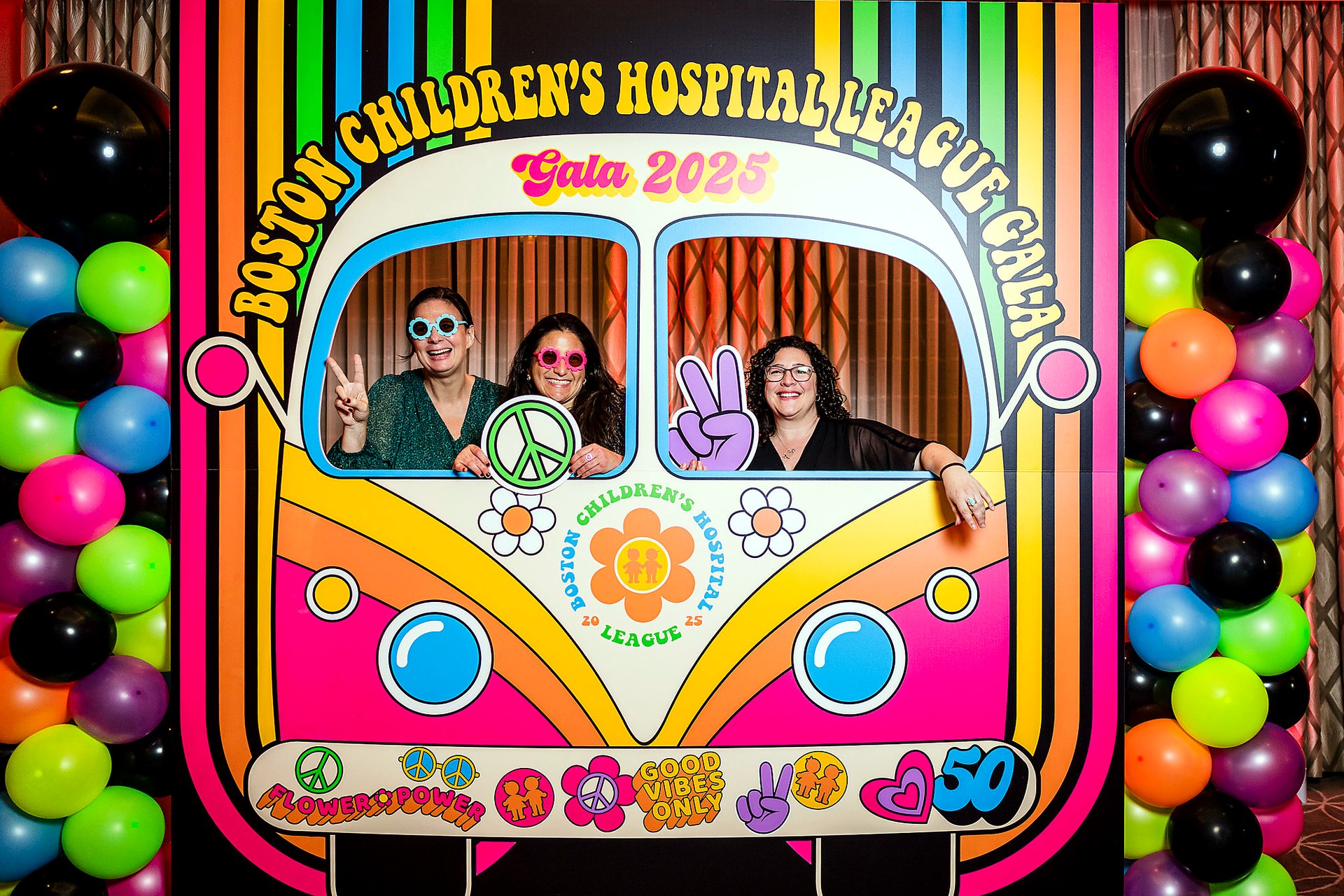 Guests using a colorful retro custom corporate gala photo activation