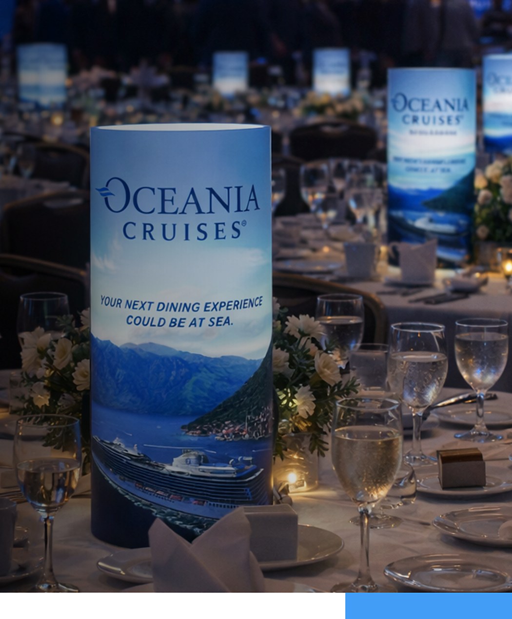 Oceania Cruises custom branded iLLUMITUBES centerpiece on a formal corporate event table